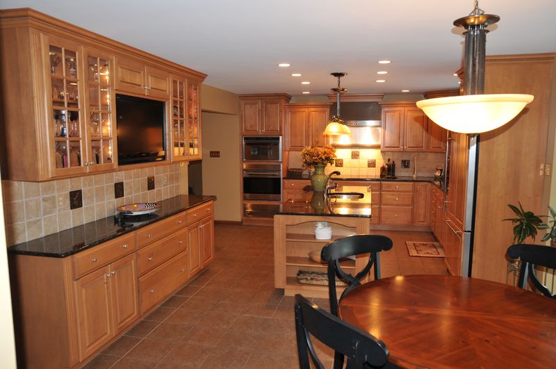 Kitchen with glass-front cabinets beside the breakfast table