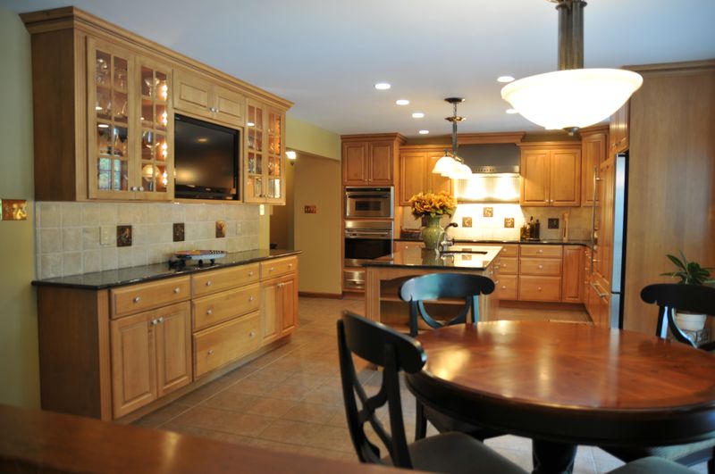Kitchen wall of built-in cabinetry with a breakfast table